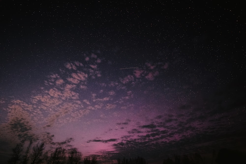 a night sky filled with stars and clouds