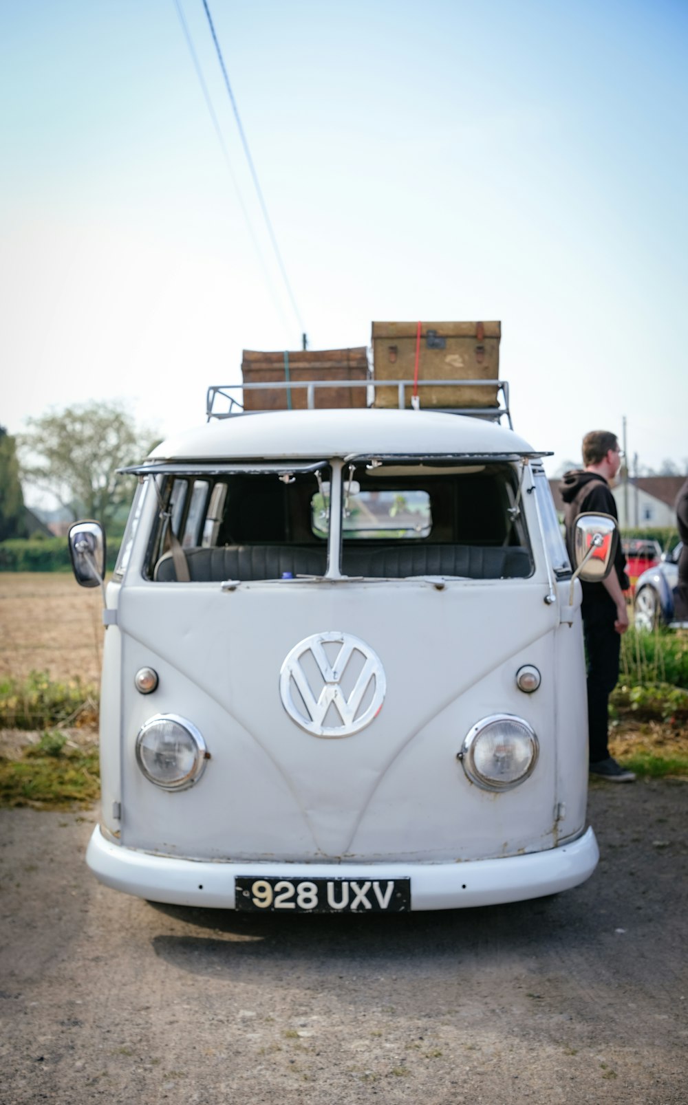 a white vw bus parked in a parking lot