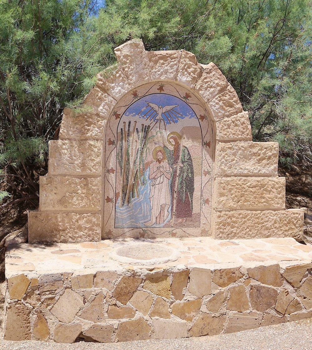 a stone arch with a painting on it