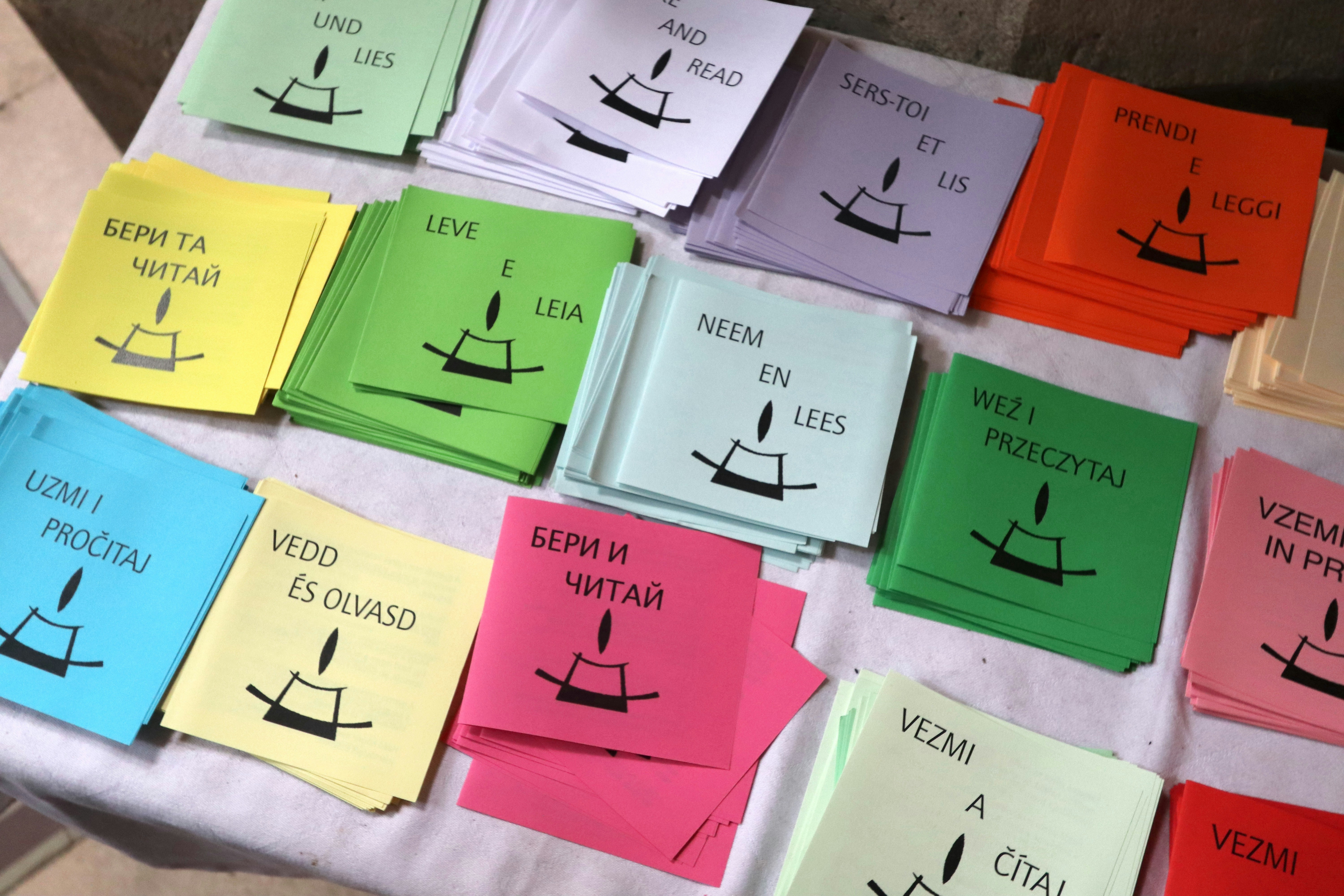 a table topped with lots of different colored papers