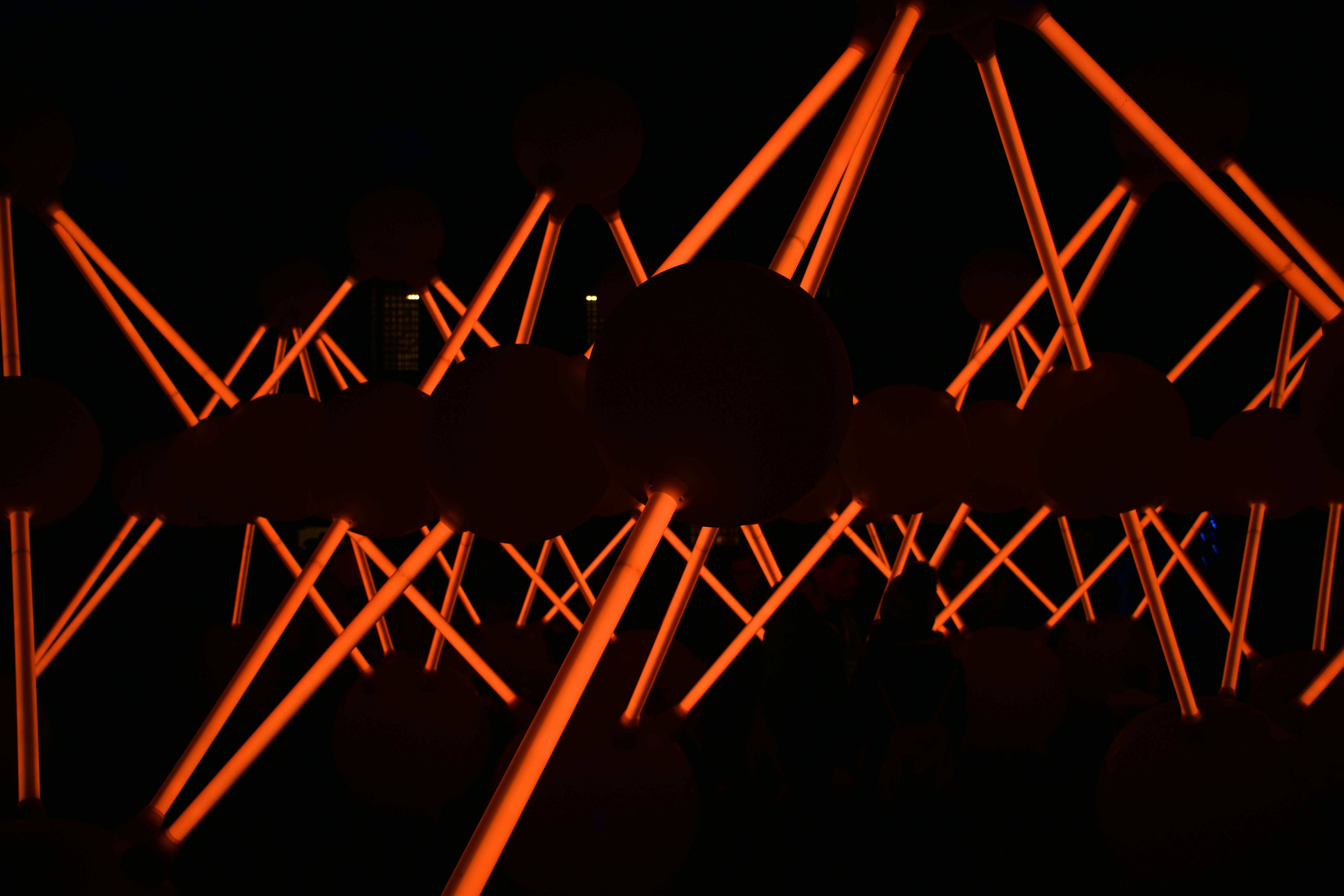 a black background with red lights in the dark