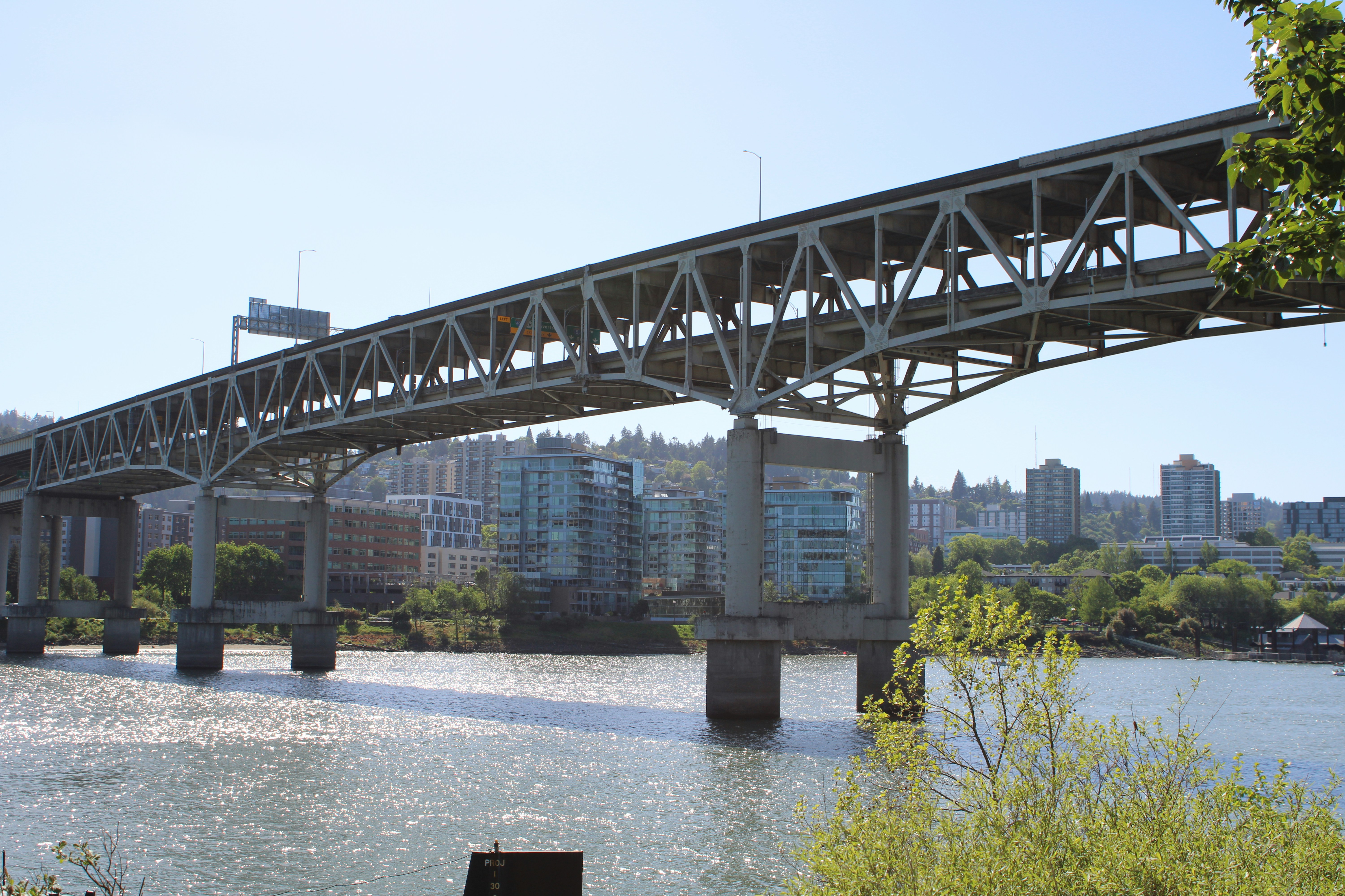 a bridge over a body of water with buildings in the background