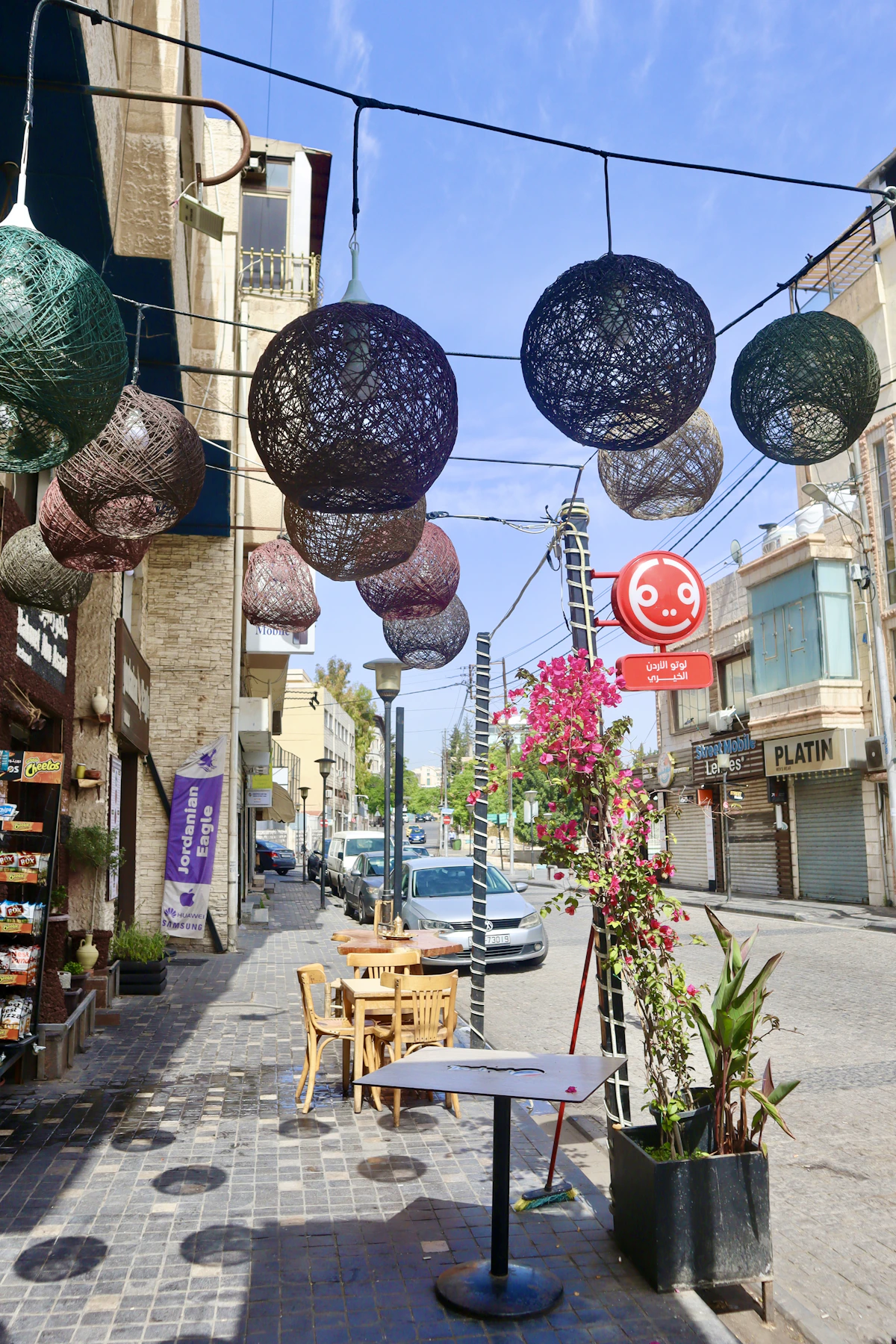 A café-lined street decorated with woven lights in central Amman