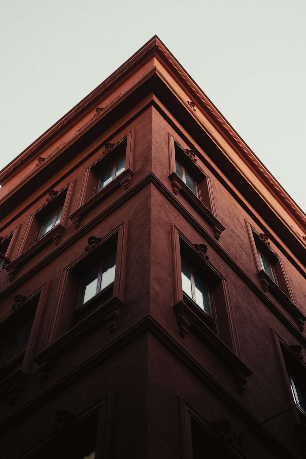 a tall building with windows and a sky background