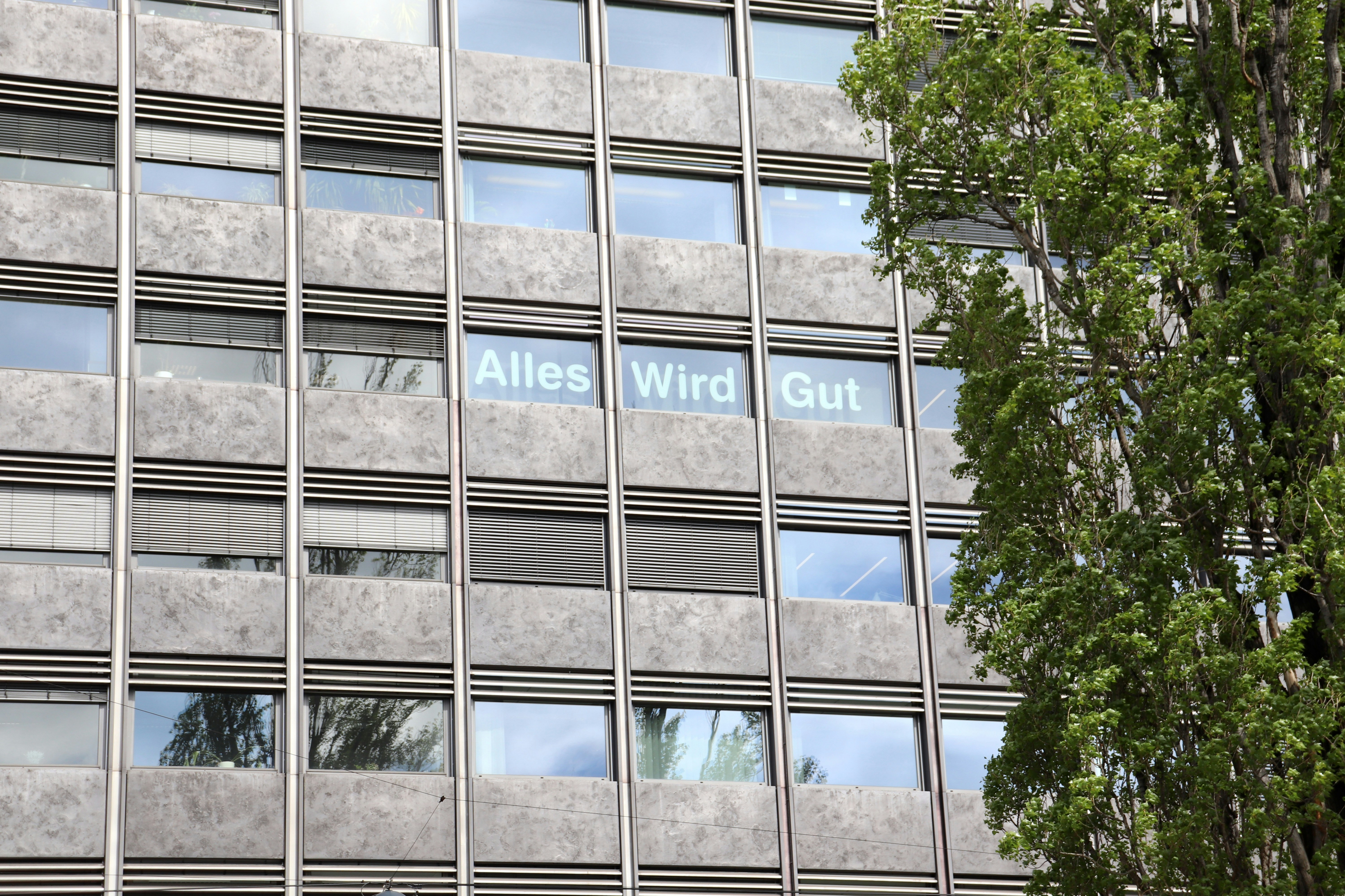 A tall building with windows and a street sign photo – Free Window ...