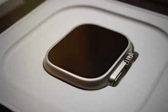 a smart phone sitting on top of a white box