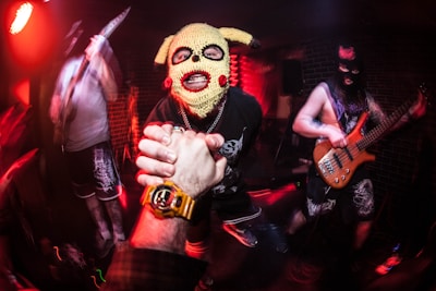 a person wearing a dog mask and holding a guitar