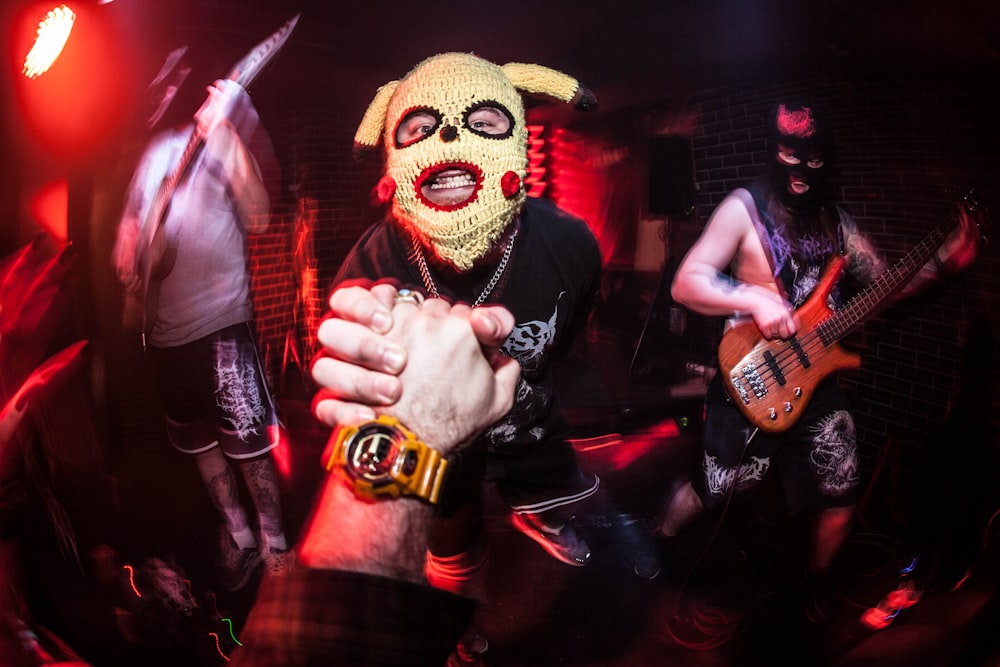 a person wearing a dog mask and holding a guitar