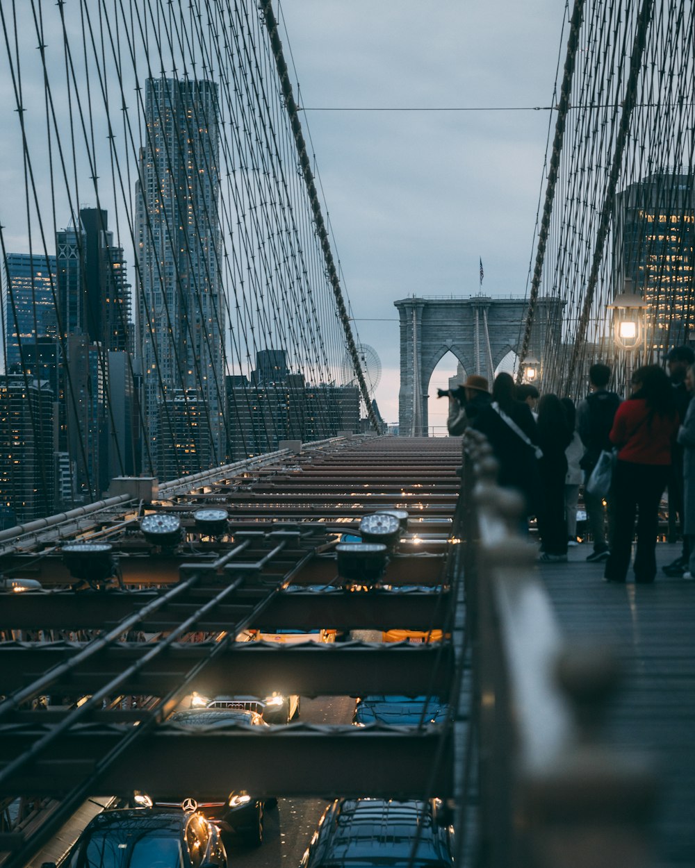 a group of people walking across a bridge