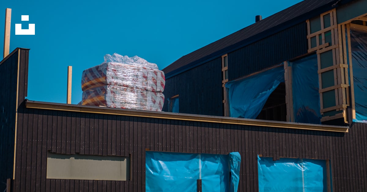 A large stack of boxes sitting on top of a building photo โ Free Oulu ...