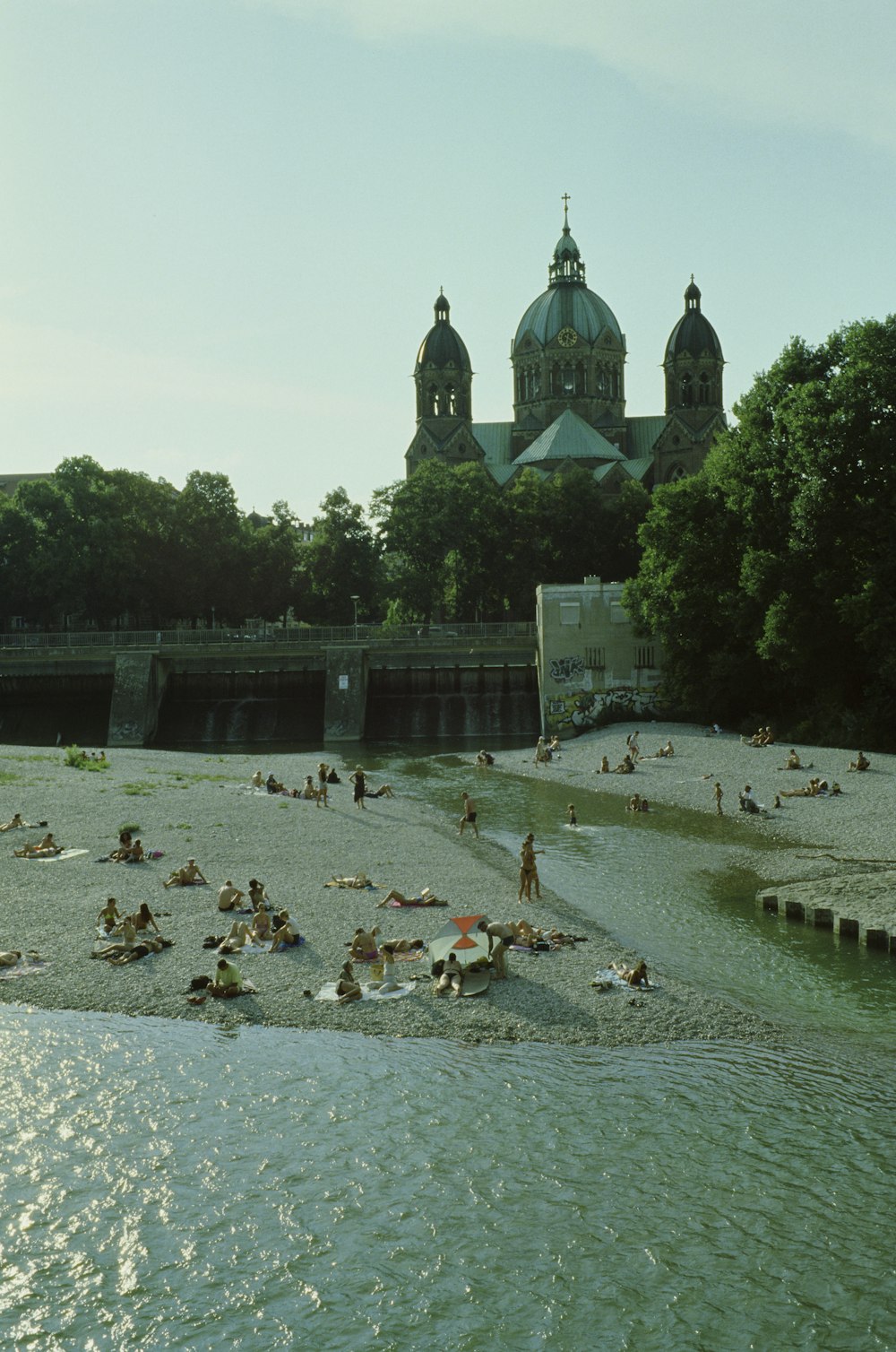 a group of people laying on top of a sandy beach