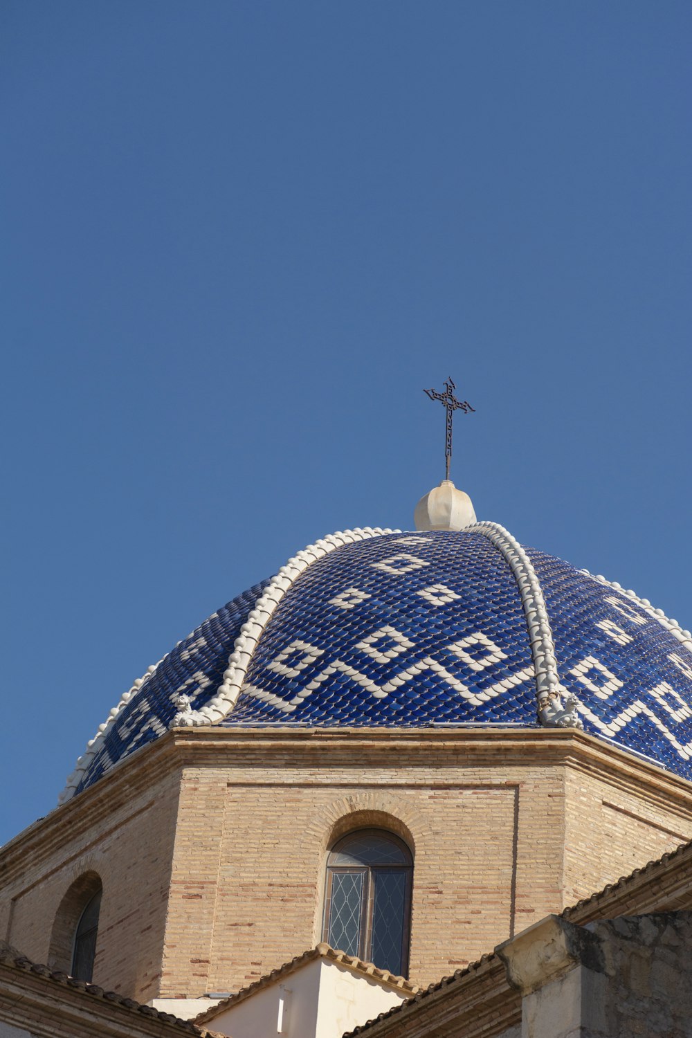 a blue and white building with a cross on top