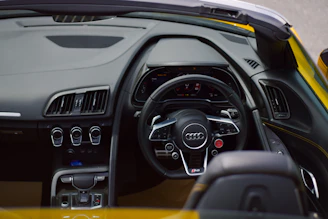 the interior of a yellow and black sports car