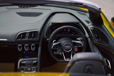 the interior of a yellow and black sports car