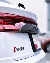 a close up of the tail lights of a white car