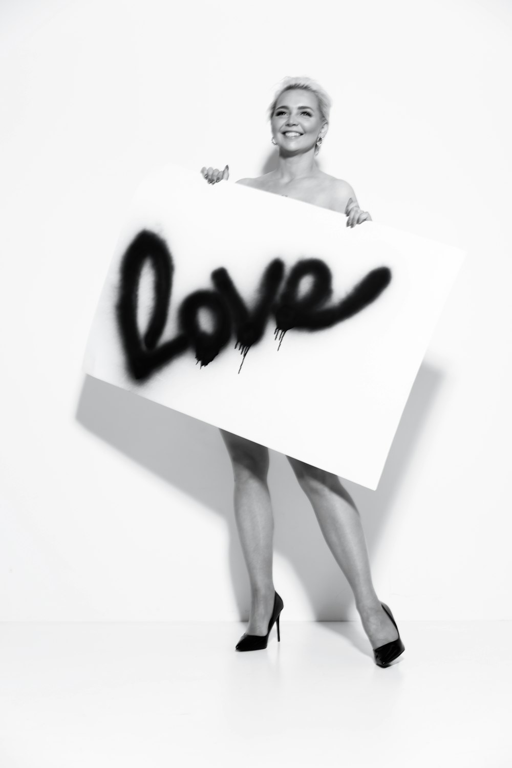 a woman holding a sign that says love