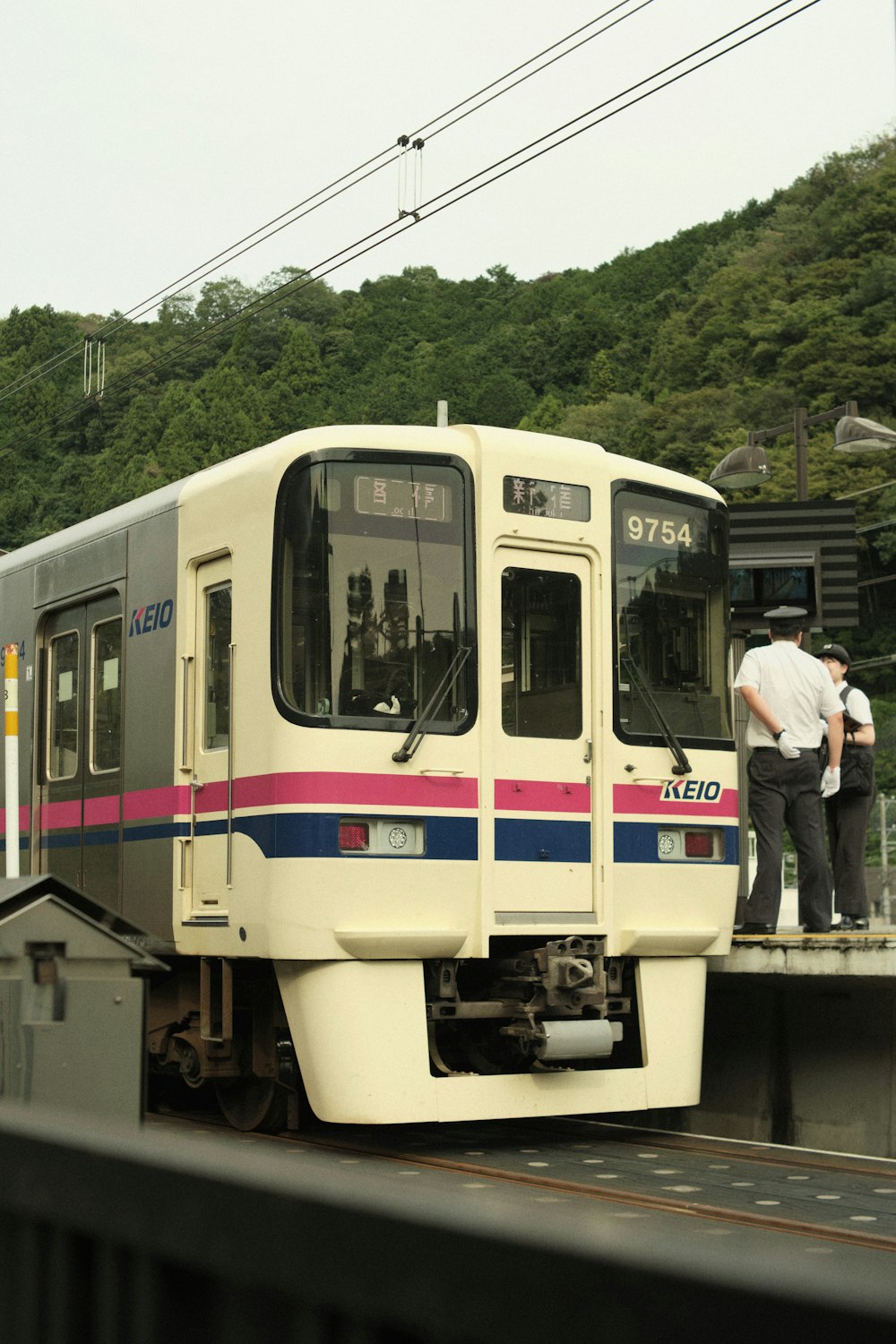 a man standing on a train platform next to a train