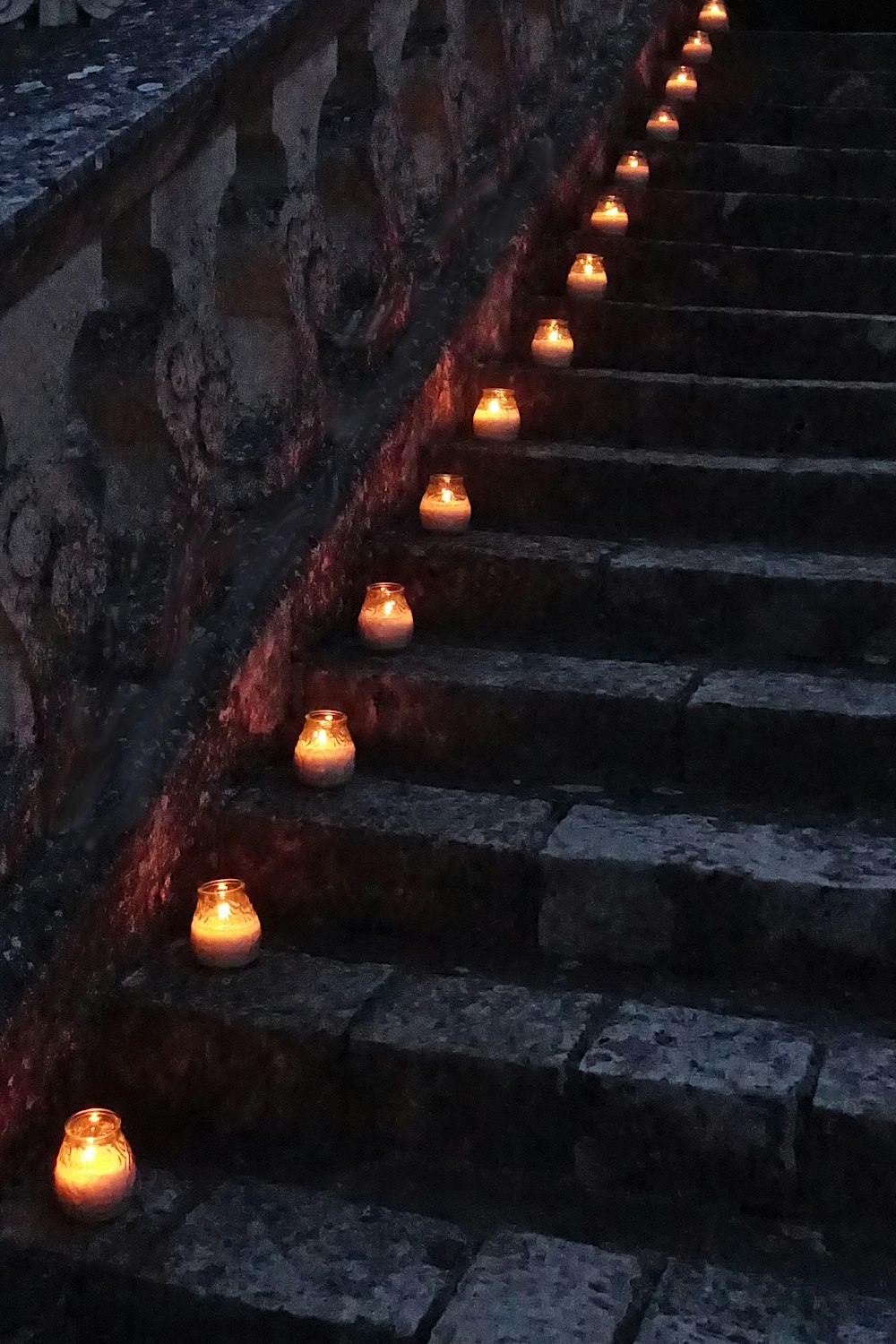 a bunch of candles that are on some steps