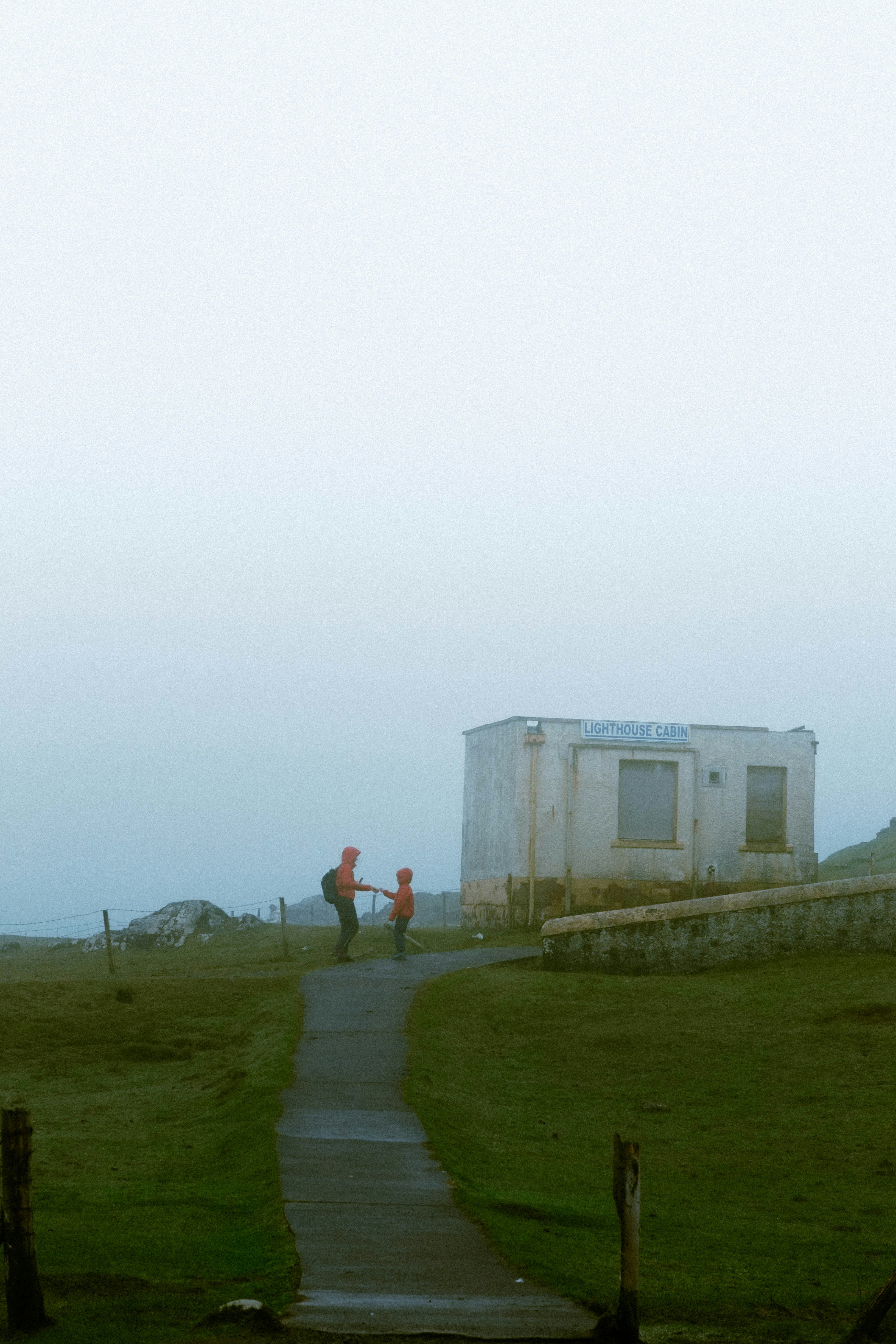 a couple of people that are standing in the grass