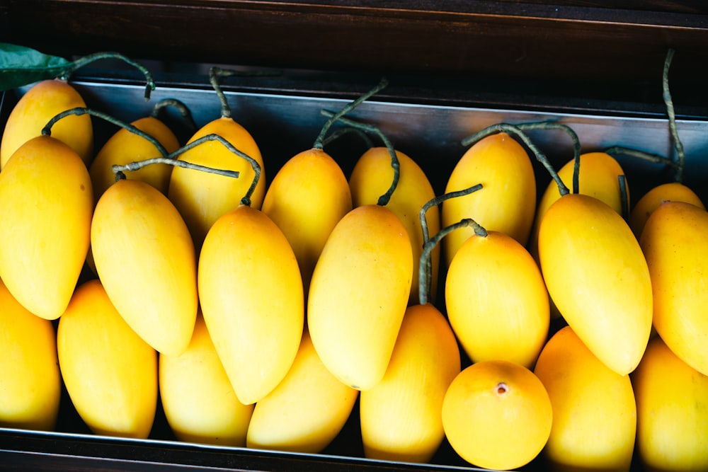 a close up of a bunch of mangoes