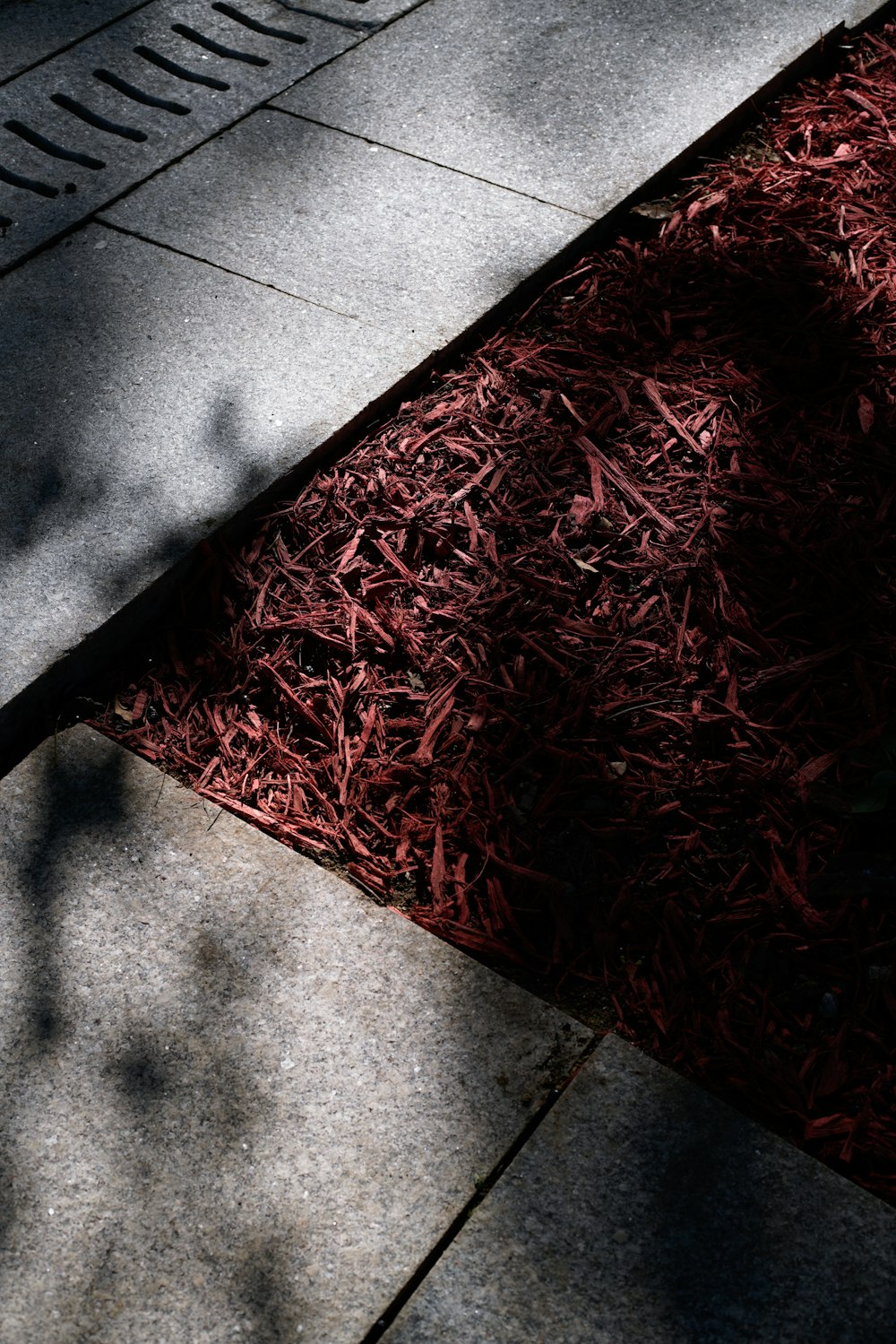 the shadow of a person standing on a sidewalk