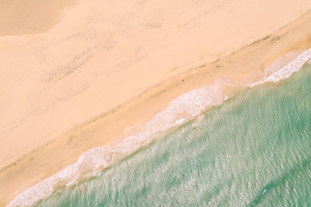 an aerial view of a sandy beach and ocean