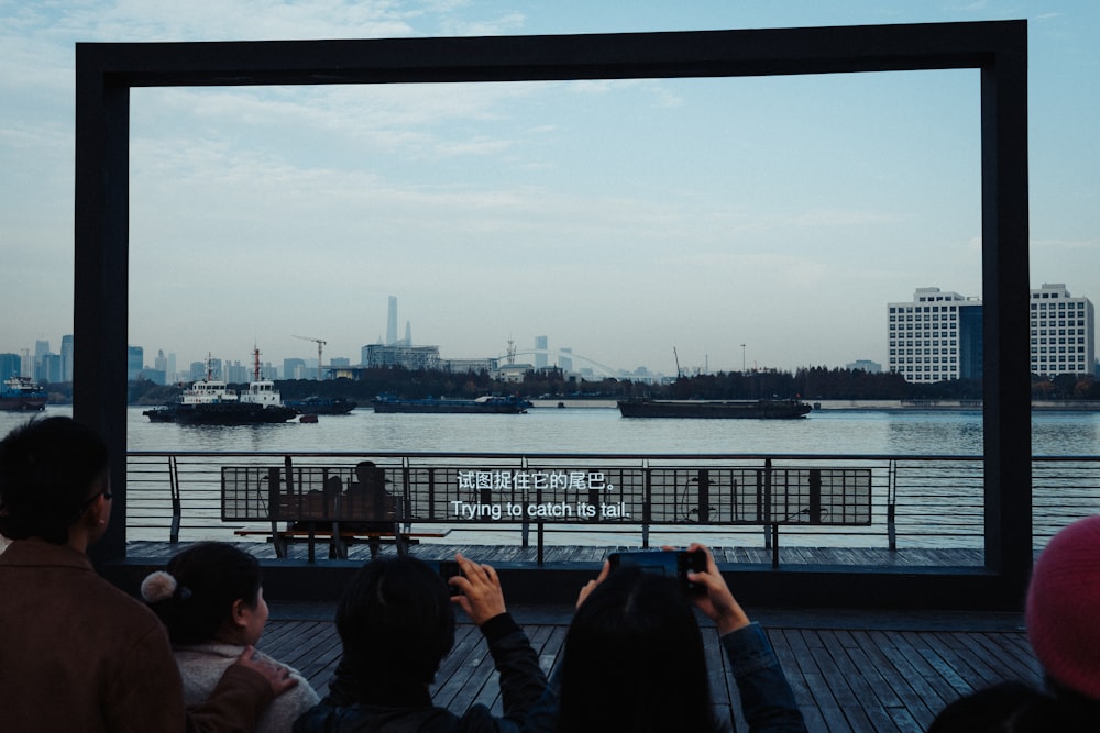 a group of people standing on top of a pier