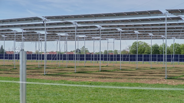 a row of metal poles in a field