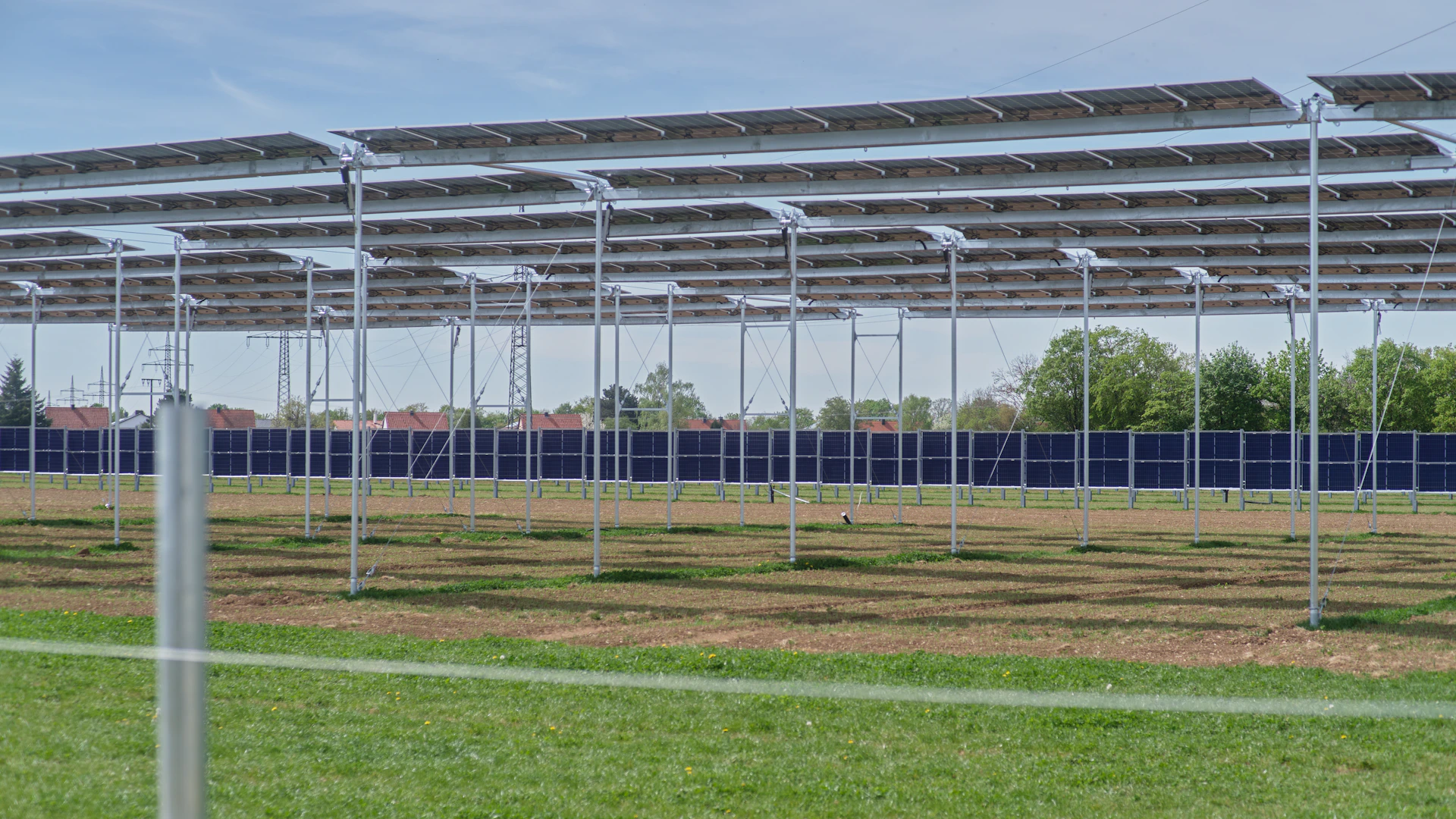 a row of metal poles in a field