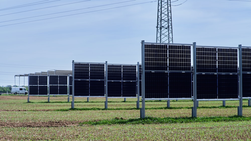 a row of solar panels in a field