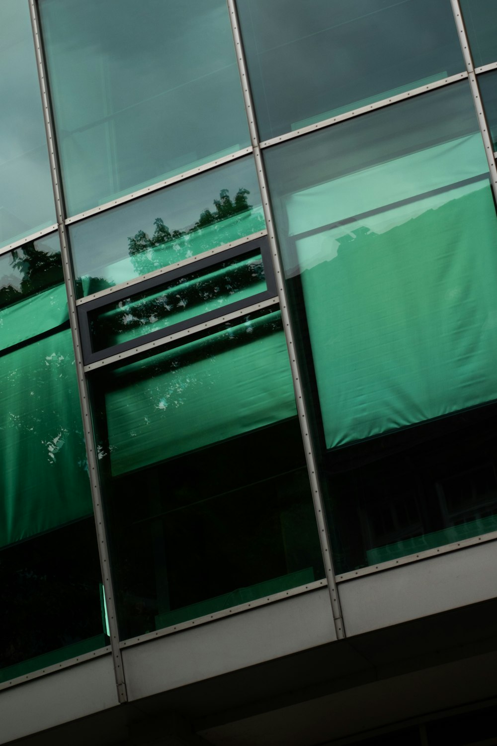 a window with a green curtain in front of it