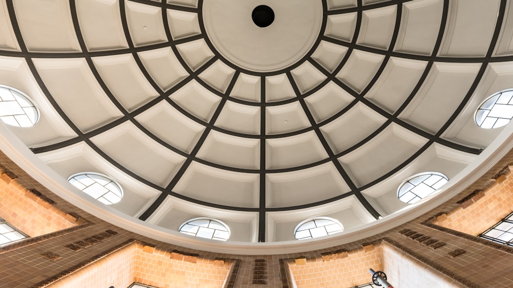 the ceiling of a large building with round windows