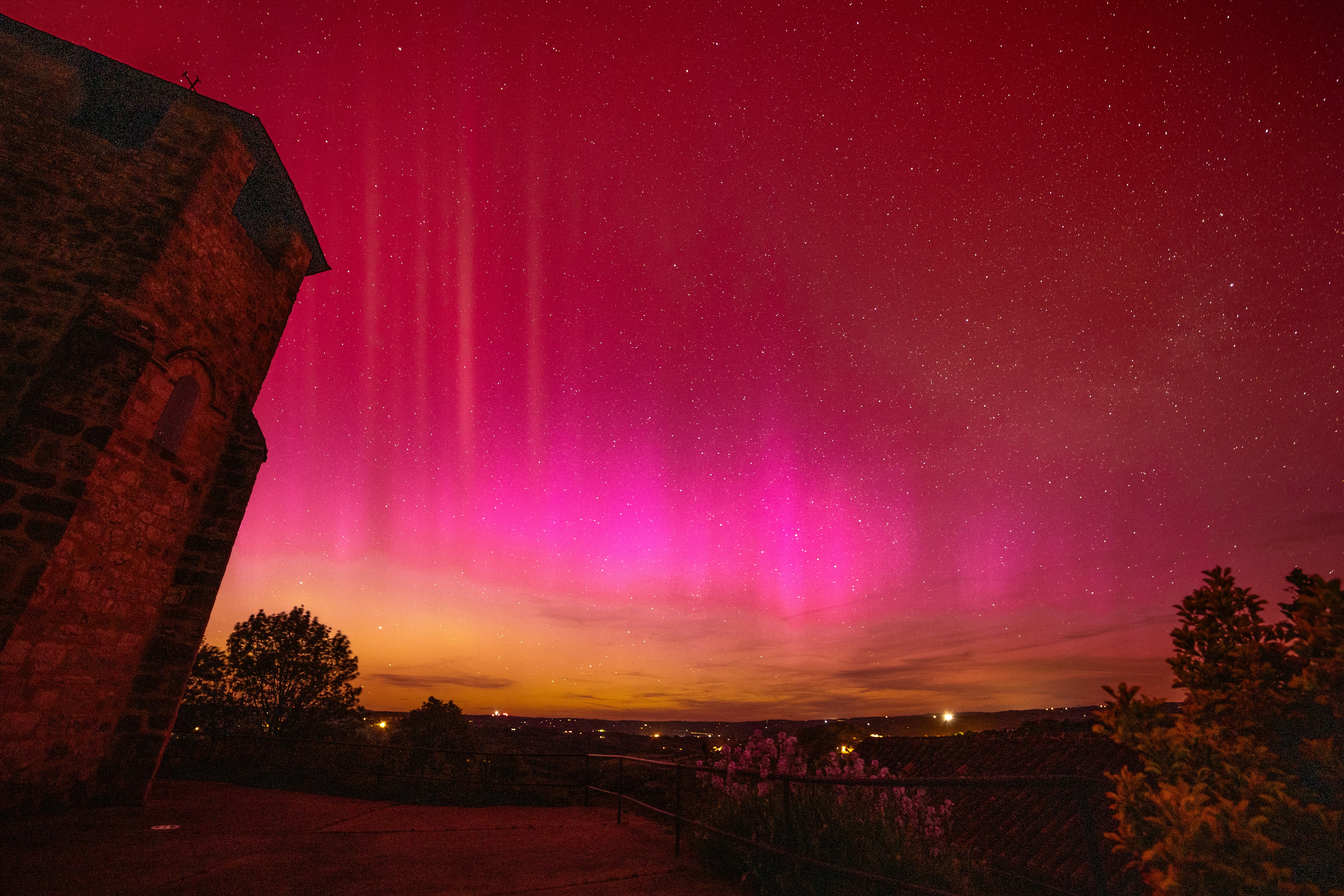 a pink and purple sky with stars and clouds