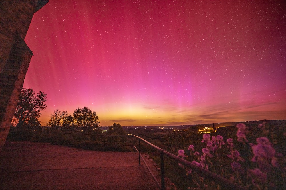 a pink and purple sky with stars and clouds