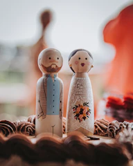 a cake topped with a couple figurines on top of a table
