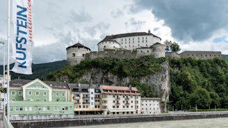 a castle on top of a hill next to a body of water