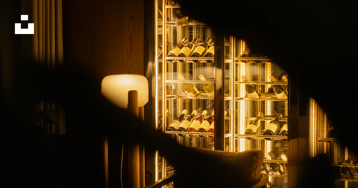 A dimly lit room with a wine rack in the background photo – Free ...