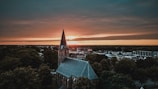 a church steeple with a sunset in the background