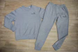 a pair of sweatpants and a sweatshirt on a wooden floor