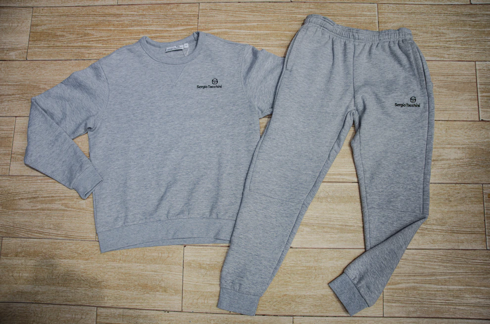 a pair of sweatpants and a sweatshirt on a wooden floor