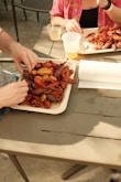 a couple of people sitting at a table with plates of food