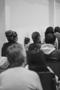 a group of people sitting in chairs in a room
