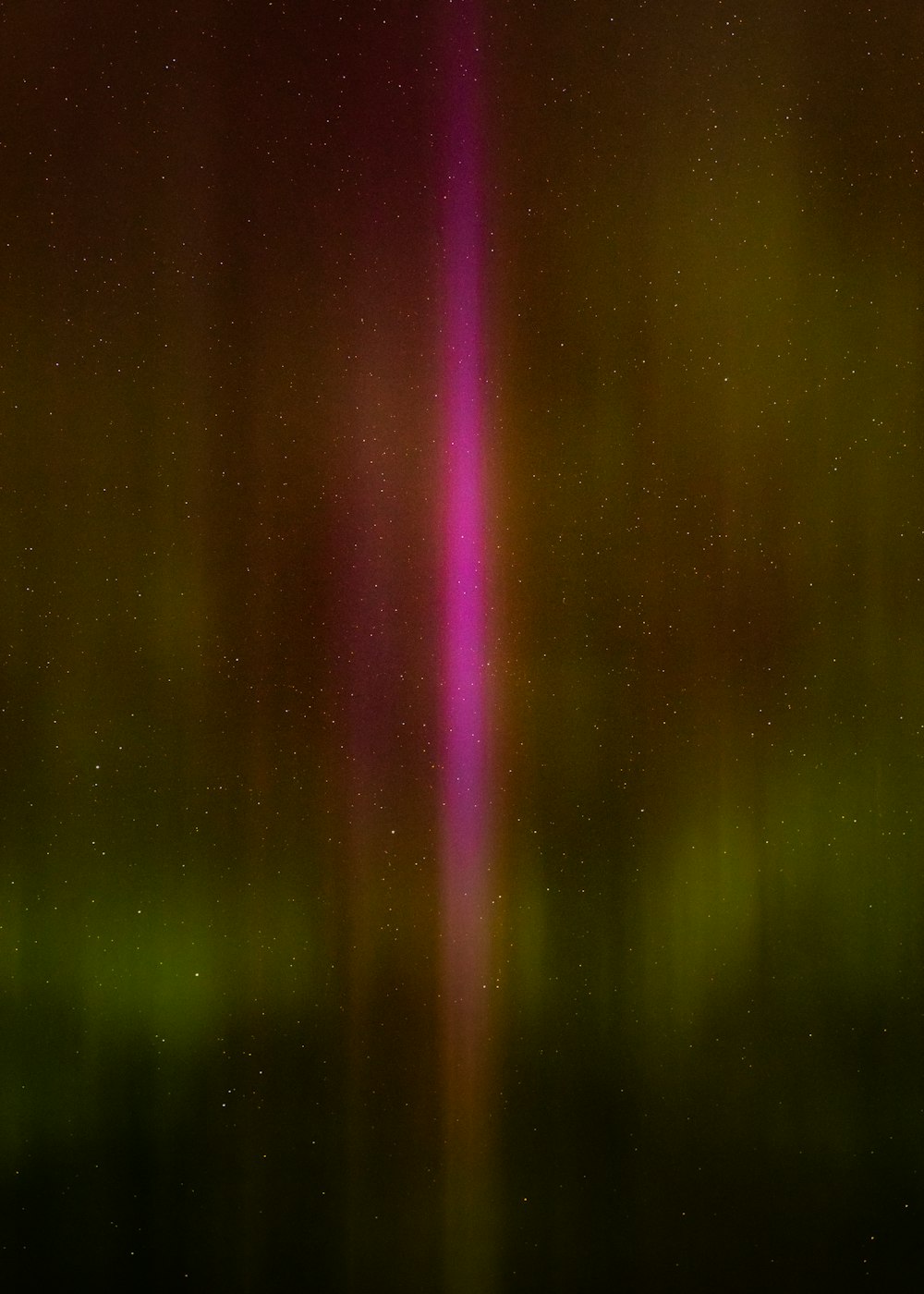 a blurry image of a pink and green light