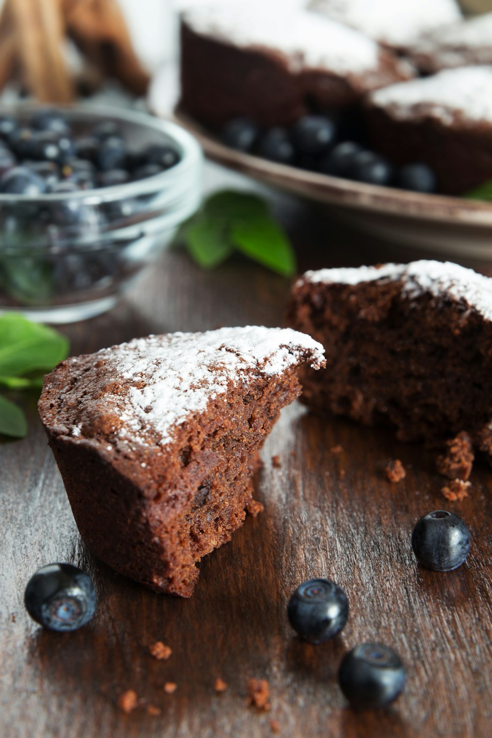 a piece of chocolate cake with powdered sugar on top