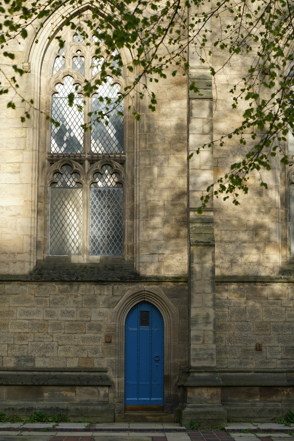 a blue door in front of a stone building