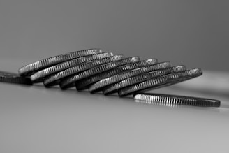 a stack of silver coins sitting on top of a table