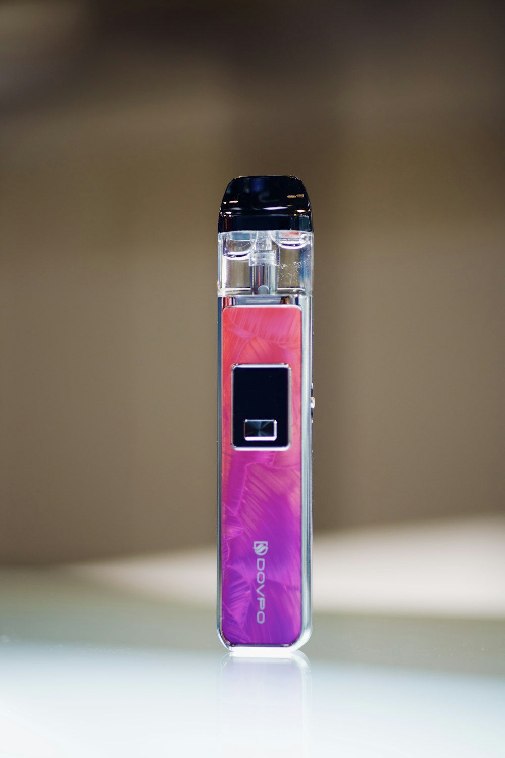 a purple and pink electronic device sitting on a table