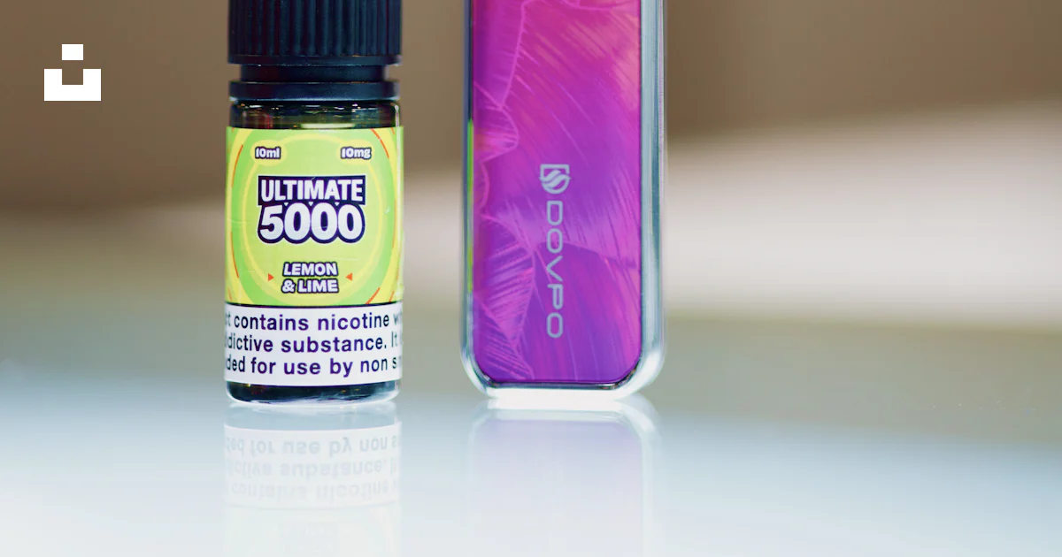 A bottle of e - liquid next to an electronic device photo – Free Nec ...