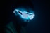 a man wearing a neon mask in the dark