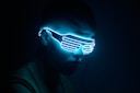 a man wearing a neon mask in the dark